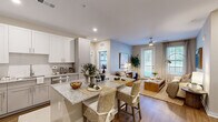 This thoughtfully designed 2-bedroom, 2-bathroom single-floor residence offers a functional and stylish open-concept layout. The kitchen is a standout feature, equipped with stainless steel appliances, white and gray shaker-style cabinetry, a white tile backsplash, and granite countertops that extend to a peninsula with bar seating — ideal for casual dining and entertaining. Wood-style flooring runs throughout the main living areas, adding warmth and cohesion to the space.

The living room is bright and welcoming, featuring a ceiling fan, large windows with natural light, and direct access to an outdoor area via a glass-paned door. The primary bedroom is a comfortable retreat with a ceiling fan, a large window, and a dedicated walk-in closet outfitted with wire shelving systems. The second bedroom is equally well-lit, featuring soft accent wall tones and ample natural light.

Both bathrooms are finished with granite-topped vanities, shaker-style cabinetry, and warm lighting. Two closets throughout the residence provide generous storage. The neutral color palette, consistent flooring, and modern finishes create a cohesive and move-in-ready living environment suited for a variety of lifestyles.