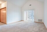 Located at 1010 N High Point Rd in Madison, WI, this two-bedroom, two-bathroom unit offers a thoughtfully designed single-floor layout. The living room is a standout feature, boasting dramatic vaulted ceilings that lend an airy, open feel to the space. Large sliding glass doors flood the room with natural light and provide direct access to an outdoor patio, offering pleasant views of the surrounding area. Soft carpeting throughout the living and bedroom areas adds warmth underfoot.

The kitchen is efficiently laid out with warm oak cabinetry offering ample storage, light-toned countertops, hardwood-style flooring, and black appliances including a refrigerator, range, and dishwasher. A breakfast bar provides a convenient transition between the kitchen and living area.

Both bedrooms are comfortably sized with neutral carpet and bright windows that bring in natural light. The primary bedroom offers a well-proportioned retreat. Two closets provide dedicated storage throughout the unit.

The two bathrooms are clean and functional, each featuring oak vanity cabinetry with white countertops and tile flooring. One bathroom includes a full tub-shower combination. An in-unit laundry area adds everyday convenience, completing this well-appointed Madison home.