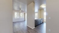 This two-story, 2-bedroom, 2-bathroom condo at 8200 Haven Avenue, Unit 6212, in Rancho Cucamonga, CA offers 1,100 square feet of well-designed living space split evenly across two floors. The main level (560 sq ft) features an open-concept kitchen and living room with wood-style flooring that flows throughout the unit. The kitchen is outfitted with stainless steel appliances—including a gas range, microwave, and refrigerator—complemented by contemporary wood-toned cabinetry and light quartz-style countertops with a peninsula sink. The living room is bright and airy, boasting multiple windows with natural light, a ceiling fan, sliding glass doors opening to a private balcony, and views of lush landscaping. The upper level (550 sq ft) houses both bedrooms, each featuring ceiling fans, wood-style flooring, and ample closet space—including a walk-in closet in the primary bedroom (140 sq ft). Both bathrooms feature tub/shower combos, modern vanities with wood-toned cabinetry, and wood-style flooring. A dedicated hallway and staircase connect the two levels, completing this clean, modern home.
