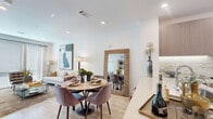 This thoughtfully designed one-bedroom, one-bathroom residence at 15 Artisan Dr. in Salem, NH offers a clean, modern aesthetic across a single well-organized floor. The open-concept living and dining area is anchored by light hardwood-style flooring, recessed lighting, and large windows that invite generous natural light. The kitchen is a standout feature, showcasing flat-front cabinetry in a warm wood tone, quartz countertops, a marble-style tile backsplash, stainless steel appliances, and an undermount sink — a highly functional and stylish space for cooking and entertaining. The living area flows seamlessly from the kitchen and dining zone, providing a bright, cohesive common area. The bedroom offers a comfortable, private retreat with a ceiling fan, a large window with sheer draping, and direct access to the closet and bathroom. The bathroom is elegantly appointed with large-format marble-look tile flooring, a floating vanity with wood-toned cabinetry, a well-lit mirror, and a full soaking tub with shower. A dedicated closet with built-in shelving provides organized storage. Light-toned flooring, crisp white walls, and modern finishes are consistent throughout, creating a cohesive and contemporary living environment.