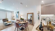 This thoughtfully designed one-bedroom, one-bathroom residence at 15 Artisan Dr. in Salem, NH offers a clean, modern aesthetic across a single well-organized floor. The open-concept living and dining area is anchored by light hardwood-style flooring, recessed lighting, and large windows that invite generous natural light. The kitchen is a standout feature, showcasing flat-front cabinetry in a warm wood tone, quartz countertops, a marble-style tile backsplash, stainless steel appliances, and an undermount sink — a highly functional and stylish space for cooking and entertaining. The living area flows seamlessly from the kitchen and dining zone, providing a bright, cohesive common area. The bedroom offers a comfortable, private retreat with a ceiling fan, a large window with sheer draping, and direct access to the closet and bathroom. The bathroom is elegantly appointed with large-format marble-look tile flooring, a floating vanity with wood-toned cabinetry, a well-lit mirror, and a full soaking tub with shower. A dedicated closet with built-in shelving provides organized storage. Light-toned flooring, crisp white walls, and modern finishes are consistent throughout, creating a cohesive and contemporary living environment.