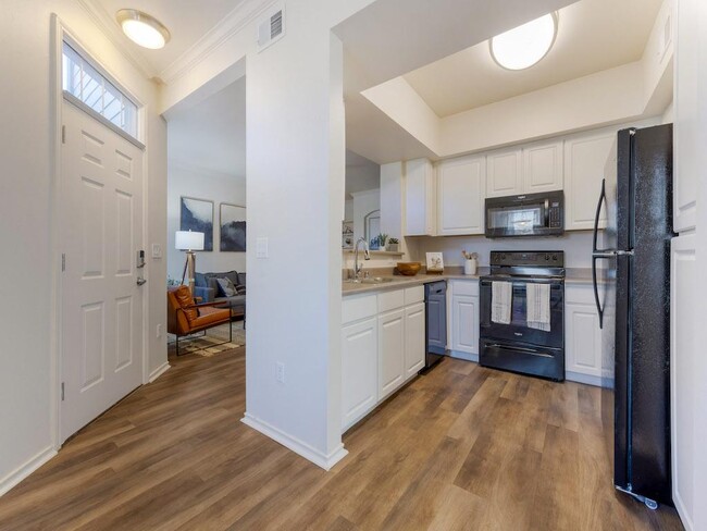 Wraparound Counter Looking into Living Room at Trailside - Trailside Apartments