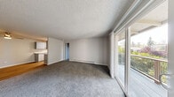 Located at 1926 W Casino Rd in Everett, WA, this one-bedroom, one-bathroom unit offers a well-organized single-floor layout with a cohesive, neutral design throughout. Wood-look flooring runs continuously across the living spaces, complemented by light gray walls and textured ceilings that add subtle dimension.

The living room is open and airy, with baseboard heating and a sliding glass door that leads directly to a private patio, allowing natural light and outdoor views of surrounding greenery to filter in. The combined dining and kitchen area is efficiently arranged, providing a functional space for daily living.

The bedroom is generously proportioned, featuring two windows that bring in ample natural light and offer views of the outdoors. A ceiling fan adds comfort, and a closet provides practical storage. A second closet is available elsewhere in the unit for additional storage needs.

The bathroom is clean and well-appointed, featuring a gray shaker-style vanity with a white countertop, a large mirror with overhead lighting, and a tub-shower combination — all finished with consistent wood-look flooring that ties the space together.

Overall, the unit presents a tidy, move-in-ready atmosphere with practical finishes and a layout that makes efficient use of its footprint.