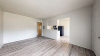 Located at 717 S Green St in Longview, Texas, this single-story, one-bedroom, one-bathroom unit offers a clean, functional layout with a bright, neutral palette throughout. Light wood-tone vinyl plank flooring runs continuously across the entire floor plan, lending a cohesive and modern feel.

The living room is open and airy, benefiting from multiple windows that invite natural light and views of surrounding greenery. A peninsula-style half-wall seamlessly connects the living area to the kitchen and dining space, creating an open-concept flow ideal for everyday living. The kitchen is well-equipped with stainless steel appliances — including a full-size refrigerator, range, and microwave — complemented by white cabinetry and a dedicated pantry for additional storage.

The hallway connects the main living area to the bedroom and bathroom, with multiple closets lining the corridor to provide generous storage capacity. The spacious primary bedroom features a ceiling fan with light fixture and a window that brings in natural light. The textured ceiling adds subtle architectural character to the room.

Throughout the unit, clean white walls, updated hardware, and consistent flooring create a well-maintained and move-in-ready environment that is both practical and inviting.
