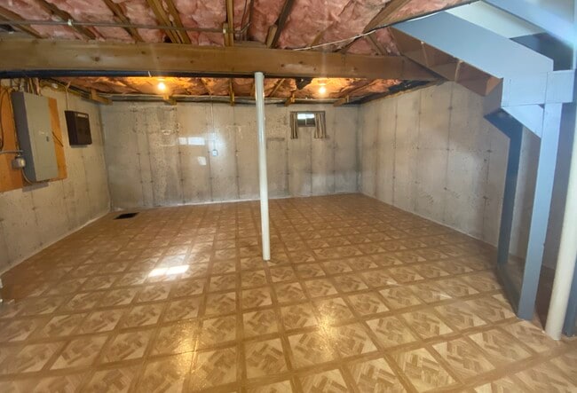 Open basement with laminate floor. - 42 Anthony St
