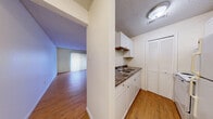 Located at 827 SW Tyler St in Topeka, Kansas, this one-bedroom, one-bathroom unit offers a practical and well-organized single-floor layout. Warm hardwood-style flooring flows consistently throughout the space, lending a cohesive and inviting feel to every room.

The entrance leads into a compact, efficiently designed kitchen featuring white cabinetry, open shelving, a double sink with dark countertops, and a louvered closet door for additional storage. The kitchen opens directly into the living room, which is bright and open, highlighted by a sliding glass door with vertical blinds that allows natural light to fill the space.

The bedroom is a comfortable, private retreat with a window fitted with horizontal blinds, a textured ceiling, and generous floor space. Three closets throughout the unit provide excellent storage capacity. A dedicated utility room adds further practicality to the layout.

The bathroom is clean and straightforward, featuring a full-size soaking tub and shower combo with built-in shelving, chrome fixtures, and tiled surround. Textured ceilings are present throughout the unit, adding a classic residential character. Overall, this unit offers a functional, no-frills living space with consistent finishes and thoughtful storage solutions.