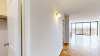 Located at 185 Prospect Ave in Hackensack, NJ, this generously sized 1-bedroom, 2-bathroom residence offers a thoughtfully designed layout across a single floor. Distinctive parquet wood flooring flows throughout the main living areas, adding warmth and character to the space. The expansive combined living and dining area is bathed in natural light, anchored by floor-to-ceiling sliding glass doors that open onto a private balcony with open outdoor views. The kitchen is well-equipped with rich wood cabinetry, granite countertops, tile flooring, and a full suite of stainless steel appliances including a refrigerator, range, microwave, and dishwasher. The spacious primary bedroom features a window with views of the surrounding landscape. A versatile den provides additional flexible living space, ideal for a home office or guest room. Five closets are distributed throughout, offering exceptional storage. Both bathrooms are finished with light tile flooring and grey vanity cabinetry; one includes a full tub/shower combination. A welcoming hallway with wall sconce lighting connects the rooms seamlessly, completing this well-rounded and functional residence.