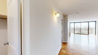 This 1200 square foot apartment, located at 185 Prospect Ave in Hackensack, NJ, offers a blend of modern comfort and classic charm. The space is thoughtfully designed with two living areas, providing ample room for relaxation and entertainment. The heart of the home is a sleek, updated kitchen featuring wood cabinetry, granite countertops, and stainless steel appliances.

The apartment boasts beautiful parquet flooring throughout, adding warmth and character to each room. Large windows, including sliding glass doors leading to a balcony, flood the space with natural light and offer picturesque views. The primary bedroom, measuring 210 square feet, provides a spacious retreat.

Two well-appointed bathrooms, one with a bathtub and the other with a modern vanity, offer convenience and style. The apartment also includes practical amenities such as closet space and a hallway for easy navigation between rooms.

The open floor plan creates a seamless flow between living spaces, perfect for modern living and entertaining. With its combination of space, style, and functionality, this apartment presents an attractive option for those seeking a comfortable urban dwelling.