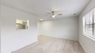 Located at 3324 Frontgate Dr in Greenville, NC, this single-floor, one-bedroom, one-bathroom unit offers a practical and efficiently designed layout. The combined living, dining, and kitchen area creates an open-concept feel, with light wood-look flooring running throughout and a ceiling fan with integrated lighting overhead. Textured ceilings add a classic touch to the bright, neutral interior.

The kitchen is equipped with white cabinetry, light stone-look countertops, a stainless steel sink, and a full-size stainless steel refrigerator. Recessed lighting illuminates the space, and a pass-through window connects the kitchen to the living and dining area, enhancing the open flow.

The bedroom is a comfortable, well-proportioned room featuring a window with blinds that allows natural light, the same light wood-look flooring, and a textured ceiling. Two closets provide ample storage throughout the unit.

The bathroom includes a full tub and shower combination with clean white surroundings. Additional practical features include a dedicated laundry area, a utility room, and a private patio — ideal for outdoor relaxation. The unit's clean, neutral palette and updated finishes make it a move-in ready home in Greenville.