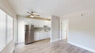 Located at 660 NE 78th St in Miami's Little Haiti neighborhood, this single-floor, one-bedroom, one-bathroom unit offers a thoughtfully laid-out living space with clean, modern finishes throughout. Light wood-style laminate flooring runs continuously through the living areas and bedroom, complementing the soft neutral tones of the walls and white trim to create a bright, cohesive atmosphere.

The combined kitchen and living area forms the heart of the unit. The kitchen stands out with sleek white cabinetry extending to the ceiling for ample storage, light grey subway tile backsplash, white quartz-style countertops, stainless steel appliances including a full-size refrigerator and gas range, and recessed lighting — a modern and functional space well-suited for everyday cooking.

The living area is open and versatile, with natural light filtering in through a window fitted with vertical blinds. The spacious bedroom offers a generous footprint, a dedicated closet with louvered doors, and a vent for climate control, keeping the space comfortable year-round.

The bathroom features white subway tile surrounding a full soaking tub with a showerhead, gold-toned fixtures, and a frosted window that allows natural light while maintaining privacy. The overall design is clean, minimal, and move-in ready.