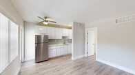 Located at 660 NE 78th St in Miami's Little Haiti neighborhood, this single-floor, one-bedroom, one-bathroom unit offers a thoughtfully laid-out living space with clean, modern finishes throughout. Light wood-style laminate flooring runs continuously through the living areas and bedroom, complementing the soft neutral tones of the walls and white trim to create a bright, cohesive atmosphere.

The combined kitchen and living area forms the heart of the unit. The kitchen stands out with sleek white cabinetry extending to the ceiling for ample storage, light grey subway tile backsplash, white quartz-style countertops, stainless steel appliances including a full-size refrigerator and gas range, and recessed lighting — a modern and functional space well-suited for everyday cooking.

The living area is open and versatile, with natural light filtering in through a window fitted with vertical blinds. The spacious bedroom offers a generous footprint, a dedicated closet with louvered doors, and a vent for climate control, keeping the space comfortable year-round.

The bathroom features white subway tile surrounding a full soaking tub with a showerhead, gold-toned fixtures, and a frosted window that allows natural light while maintaining privacy. The overall design is clean, minimal, and move-in ready.