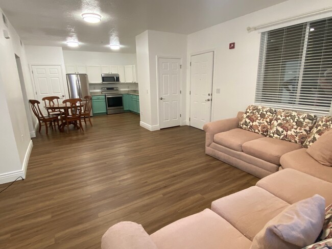 Large open-concept living/dining/kitchen. Water resistant wood laminate throughout condo - 502 S 1040 E