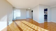 Located at 2 Secord Ave in Toronto's east end, this 2-bedroom, 1-bathroom unit offers a thoughtfully laid-out floor plan with a welcoming entrance that leads into the main living areas. The spacious living and dining rooms are bathed in natural light, courtesy of large floor-to-ceiling sliding glass doors that open onto a private balcony showcasing sweeping panoramic views of the Toronto skyline. A elegant chandelier accents the dining area, while polished parquet hardwood flooring flows consistently throughout the living spaces and both bedrooms, lending warmth and character to the interior.

The kitchen is well-equipped with rich dark-wood cabinetry, granite-style countertops, a stainless steel refrigerator, and light ceramic tile flooring, offering a functional and stylish cooking space. Both bedrooms are generously proportioned, featuring bright windows with open city views, parquet floors, and ample closet storage — three closets are distributed throughout the unit. The primary bedroom is notably spacious, providing a comfortable personal retreat.

The full bathroom is finished with neutral ceramic tile, a combined tub and shower, a dark wood vanity with stone countertop, and a bright window. With abundant natural light, city views, and quality finishes throughout, this unit offers a comfortable and functional living environment.