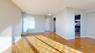 Located at 2 Secord Ave in Toronto's east end, this 2-bedroom, 1-bathroom unit offers a thoughtfully laid-out floor plan with a welcoming entrance that leads into the main living areas. The spacious living and dining rooms are bathed in natural light, courtesy of large floor-to-ceiling sliding glass doors that open onto a private balcony showcasing sweeping panoramic views of the Toronto skyline. A elegant chandelier accents the dining area, while polished parquet hardwood flooring flows consistently throughout the living spaces and both bedrooms, lending warmth and character to the interior.

The kitchen is well-equipped with rich dark-wood cabinetry, granite-style countertops, a stainless steel refrigerator, and light ceramic tile flooring, offering a functional and stylish cooking space. Both bedrooms are generously proportioned, featuring bright windows with open city views, parquet floors, and ample closet storage — three closets are distributed throughout the unit. The primary bedroom is notably spacious, providing a comfortable personal retreat.

The full bathroom is finished with neutral ceramic tile, a combined tub and shower, a dark wood vanity with stone countertop, and a bright window. With abundant natural light, city views, and quality finishes throughout, this unit offers a comfortable and functional living environment.