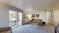 Located at 2610 Deloak Dr in Saint Louis, MO, this three-bedroom, one-bathroom unit offers a well-organized single-floor layout designed for comfortable everyday living. The carpeted living room serves as the heart of the home, featuring a ceiling fan, open sightlines to a dining area, and a sliding glass door that leads to a private balcony overlooking mature trees and green outdoor space, filling the room with natural light. The kitchen is equipped with warm oak cabinetry, ample counter space, a full suite of white appliances including a dishwasher, and easy-care tile flooring. The primary bedroom is a generously sized retreat with plush carpet and room for a full furniture arrangement. The two additional bedrooms are comfortably sized with carpeted floors, natural light from windows, and closet storage — suitable for sleeping quarters or a home office. A third bedroom with a built-in sliding closet sits conveniently near the full bathroom, which includes a combined tub and shower. Throughout the unit, neutral wall tones and consistent carpet create a cohesive, move-in ready atmosphere. A dedicated closet provides additional storage to complement the practical floor plan.