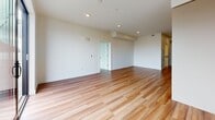 Unit 323 at 532 Union Street is a modern 2-bedroom, 1-bathroom condominium spanning 660 square feet in Oakland, CA. The open-concept living and kitchen area features warm hardwood flooring, recessed lighting, and a sliding glass door that opens to a private balcony with outdoor views, filling the space with natural light. The kitchen is outfitted with contemporary two-tone cabinetry, white quartz countertops, and a full suite of stainless steel appliances including a gas range, over-the-range microwave, dishwasher, and refrigerator. The spacious living area provides a clean, bright canvas with crisp white walls and hardwood floors. The primary bedroom measures 160 square feet and includes a sliding door closet and plush carpeting, while the second bedroom also features large windows that invite in natural light and outdoor views. The full bathroom is finished with large-format tile flooring, a soaking tub with shower, and a vanity with ample counter space. This well-appointed unit combines modern design with functional living in a vibrant Oakland location.