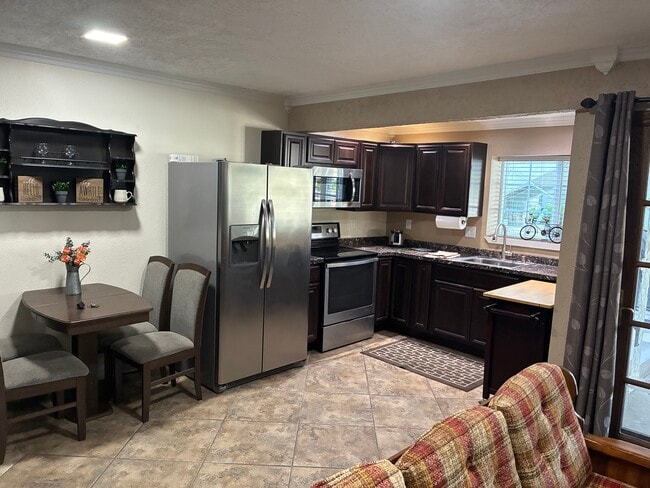 Fully equipped kitchen with refrigerator, stove, microwave, disposal, dishwasher. - 29984 Big Range Rd