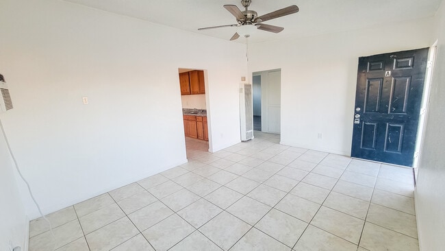 Living room with ceiling fan and natural light - 5527 Baileya Ave