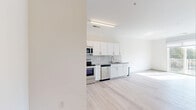 Located at 4225 Innslake Dr in Glen Allen, Virginia, this thoughtfully designed one-bedroom, one-bathroom residence offers a clean, modern aesthetic across a single level. The open-concept layout seamlessly connects the kitchen, dining, and living areas, creating a cohesive and functional living space bathed in natural light.

The kitchen is a standout feature, showcasing white shaker-style cabinetry extending to the ceiling, granite countertops, a classic subway tile backsplash, and a full suite of stainless steel appliances including a refrigerator, electric range, built-in microwave, and dishwasher. Light hardwood-style flooring flows throughout the main living areas, lending warmth and continuity to the space.

The bedroom is a serene retreat with a ceiling fan, a large window framing views of the surrounding greenery, and access to a walk-in closet with wire shelving for organized storage. The full bathroom features light tile flooring and a tub/shower combination with brushed gold fixtures, offering a clean and classic finish.

Additional highlights include an in-unit laundry area with a stacked washer and dryer, a bonus room providing flexible utility, and abundant natural light throughout. This well-appointed residence combines practicality and modern style in a convenient Glen Allen location.