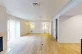 Located at 8365 Dix Ellis Trail in Jacksonville, FL, this single-floor unit offers a well-organized layout that maximizes every square foot of its compact footprint. Light wood flooring runs throughout, creating a cohesive and bright aesthetic across all rooms.

The living room is a welcoming space anchored by a tile-surround fireplace and features a sliding glass door that invites natural light and provides outdoor access. Vertical blinds offer privacy while maintaining the room's airy feel. Wall-mounted light sconces add a warm, functional touch to the living area.

The kitchen is efficiently designed with warm yellow cabinetry, granite countertops, and a full suite of stainless steel appliances, including a refrigerator, dishwasher, electric range, and over-the-range microwave. A marble-topped bar table with seating provides a casual dining option within the kitchen space. Recessed lighting illuminates the area effectively.

The bathroom is clean and functional, featuring a tiled tub-shower combination, toilet, and wood-look flooring. Two closets offer practical storage solutions, and a dedicated utility room adds further functionality to the unit. The textured ceilings and neutral wall tones throughout contribute to a simple, move-in-ready atmosphere.
