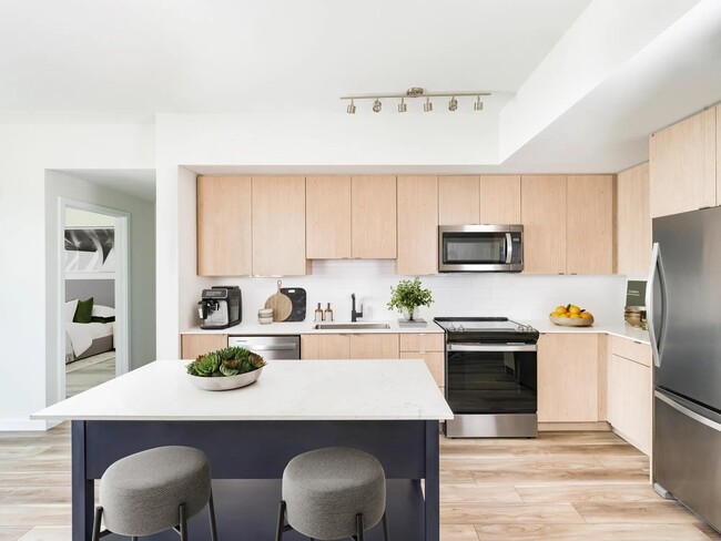 Contemporary kitchens at Modera Aventura showcase clean lines, warm finishes, and thoughtful design. - Modera Aventura