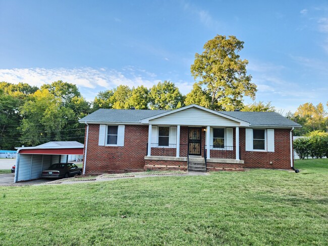 2 car attached carport with extra parking in driveway. Rocking chair covered front porch. - 139 Saratoga Dr