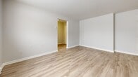 Located at 252 Conacher Dr in Kingston, Ontario, this one-bedroom, one-bathroom unit offers a practical and well-appointed layout across a single floor. Light-toned wood-look flooring runs throughout the space, creating a cohesive and clean aesthetic from room to room.

The living room is a comfortable, open area bathed in natural light from a wide window overlooking the surrounding neighbourhood. Baseboard heating ensures year-round warmth. The space connects smoothly to the rest of the unit via a central hallway.

The kitchen is a standout feature, equipped with stainless steel appliances including a range, over-the-range microwave, and dishwasher. White shaker-style cabinetry, open shelving, and a classic white subway tile backsplash contribute to a clean, modern aesthetic. The layout is efficient and functional.

The bedroom is a bright, cozy retreat with a large window that allows ample natural light and views of the neighbourhood. A baseboard heater keeps the room comfortable. The unit includes three closets, offering generous storage options.

The bathroom features full-height white tile surrounding a soaker tub and shower combination, a window for natural ventilation, and a clean, timeless finish. The overall ambiance of the unit is bright, neutral, and move-in ready.
