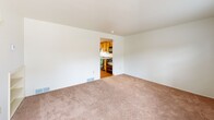 Located at 10 Sandune Dr in Pittsburgh, PA 15239, this two-bedroom, one-bathroom home is spread across two floors, offering a practical and comfortable layout. The main level features a carpeted living room with natural light from a front-facing window, a built-in shelving unit, and a staircase leading to the upper level. The kitchen is well-equipped with warm wood cabinetry, granite-style countertops, and black appliances including a range, microwave, refrigerator, and dishwasher. A sliding glass door in the kitchen opens to a rear patio and grassy outdoor area, bringing in additional natural light and views of the greenery outside. A utility room is also found on this floor. Upstairs, the spacious primary bedroom features plush carpeting, a ceiling fan with light fixture, mirrored sliding closet doors, and a window overlooking the surroundings. The second bedroom is similarly carpeted and includes a double-door closet, a ceiling-mounted light fixture, and a window with natural light. The shared full bathroom is clean and bright, complete with hardwood-style flooring, a vanity with storage, a toilet, and a tub-shower combination with a window above. Both floors are thoughtfully arranged to maximize the use of available space throughout the home.