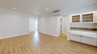 Located in the prestigious Bel Air neighborhood of Los Angeles, this single-story 2-bedroom, 2-bathroom residence offers a clean, modern aesthetic throughout. Light hardwood flooring flows seamlessly across the open living areas and bedrooms, creating a warm and cohesive feel. The living spaces are bright and airy, with recessed lighting, crown molding, and a wall-mounted mini-split HVAC system. A built-in white cabinetry unit with granite countertop adds a functional and stylish accent to the dining area, which also features a large window with plantation-style blinds that bring in generous natural light. The kitchen is well-equipped with white shaker-style cabinetry, granite countertops, stainless steel appliances including a gas range, microwave, and refrigerator, as well as tile flooring and a window above the sink. Both bathrooms are tastefully updated, featuring tub-shower combinations with glass sliding doors, vertical subway tile surrounds, tile flooring, and windows for natural ventilation. The spacious primary bedroom includes a ceiling fan and mirrored sliding closet doors. The second bedroom is comfortably sized with a closet and natural light. Hallways connect the rooms efficiently, completing this thoughtfully designed home.
