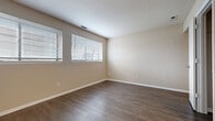 Located at 2200 S Rock Rd in Wichita, Kansas, this 2-bedroom, 1-bathroom single-floor unit offers a practical and well-appointed layout. The living room is bright and welcoming, featuring wood-look laminate flooring and two windows fitted with blinds that allow for generous natural light. The kitchen is a functional highlight, equipped with white cabinetry, granite-style countertops, a decorative tile backsplash with an accent border, a gas range, dishwasher, and ample upper and lower cabinet storage. The primary bedroom is generously proportioned, offering wood-look flooring, dual windows, and a textured ceiling that adds subtle dimension. The secondary bedroom is carpeted and similarly bright, with a window overlooking the outdoors. The shared full bathroom features wood-look flooring, a white vanity with granite-style countertops, and a full tub-shower combo. Throughout the unit, neutral warm-beige tones on the walls create a cohesive and inviting atmosphere. Three closets provide excellent storage capacity, while a connecting hallway ties the layout together efficiently. The entry area features textured walls and durable hard-surface flooring, making for a clean and practical welcome into the home.