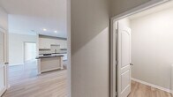 Located in Tampa, FL, this well-appointed single-story home offers three bedrooms and three full bathrooms across a thoughtfully designed floor plan. Light wood-look flooring flows throughout, complementing the clean, neutral color palette that gives the space a bright and airy feel.

The kitchen serves as a central gathering point, featuring white shaker cabinetry, a classic subway tile backsplash, dark granite countertops, stainless steel appliances, and a center island with additional storage — all opening seamlessly to the adjoining living area. Recessed lighting enhances the space's modern aesthetic.

Each of the three bedrooms offers a comfortable footprint with ceiling fans and ample natural light. The generously sized primary bedroom includes an impressive walk-in closet outfitted with a custom organizer system featuring shelving, drawers, and dual hanging rods — maximizing storage efficiency.

The bathrooms are finished with white vanity cabinetry and dark granite countertops. One bathroom includes a soaking tub surrounded by warm-toned tile. A dedicated laundry room with a full-size washer and dryer adds everyday convenience. The home's single-level layout, combined with its modern finishes, makes for a functional and comfortable living environment.