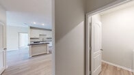 Located in Tampa, FL, this well-appointed single-story home offers three bedrooms and three full bathrooms across a thoughtfully designed floor plan. Light wood-look flooring flows throughout, complementing the clean, neutral color palette that gives the space a bright and airy feel.

The kitchen serves as a central gathering point, featuring white shaker cabinetry, a classic subway tile backsplash, dark granite countertops, stainless steel appliances, and a center island with additional storage — all opening seamlessly to the adjoining living area. Recessed lighting enhances the space's modern aesthetic.

Each of the three bedrooms offers a comfortable footprint with ceiling fans and ample natural light. The generously sized primary bedroom includes an impressive walk-in closet outfitted with a custom organizer system featuring shelving, drawers, and dual hanging rods — maximizing storage efficiency.

The bathrooms are finished with white vanity cabinetry and dark granite countertops. One bathroom includes a soaking tub surrounded by warm-toned tile. A dedicated laundry room with a full-size washer and dryer adds everyday convenience. The home's single-level layout, combined with its modern finishes, makes for a functional and comfortable living environment.