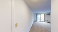 Located at 84 Hawthorne Dr N, Unit 23C in New London, CT, this one-bedroom, one-bathroom residence offers a straightforward and functional single-floor layout. The unit is part of a multi-story residential building set amid well-maintained green grounds, with a balcony that overlooks the surrounding complex and landscaped common areas.

The kitchen is efficiently designed, featuring white cabinetry with ample upper and lower storage, rich brown stone-look countertops, a tiled backsplash, a double sink, a dishwasher, and an electric range. Light wood-style flooring adds warmth to the space.

The living area and bedroom are finished with wall-to-wall carpeting in a neutral tone, providing a comfortable and cohesive feel throughout. The bedroom, a well-proportioned private retreat, benefits from a window that brings in natural light and connects visually to the outdoors. A baseboard heating unit ensures year-round comfort. Walls throughout are clean and white, lending a bright and open atmosphere to the interior.

The bathroom is equipped with a full-size combination tub and shower unit with chrome fixtures, complemented by clean, light-toned walls. The layout of the unit makes efficient use of its footprint, offering a livable and manageable space well-suited for individuals or couples seeking a convenient home in New London.