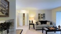 Located at 200 High Ridge Dr in Sanford, North Carolina, this single-floor residence offers a welcoming and well-appointed living environment. The living area serves as the heart of the home, featuring plush carpeting in a neutral tone that complements the soft, cream-colored walls. Abundant overhead lighting creates a warm and inviting ambiance throughout the space. The room is thoughtfully laid out to accommodate comfortable seating arrangements, with ample room for both relaxation and entertaining. Decorative wall art adds a touch of personality, while the clean, bright aesthetic keeps the space feeling open and airy. A folding door reveals access to a closet or utility area, offering practical built-in storage solutions. The seamless flow between spaces and the consistent use of light, neutral finishes give the home a cohesive and polished feel. Overall, the residence balances functional design with a comfortable, understated elegance suited for everyday living.