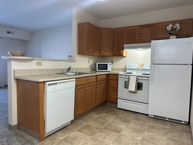 Kitchen with breakfast bar - South Pointe Senior Apartments