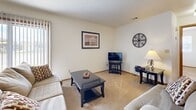 Located at 105 Lisa St in Rincon, Georgia, this single-floor, one-bedroom, one-bathroom home offers a practical and comfortable layout across a compact but efficiently organized footprint. The living room is a welcoming space with soft carpeting, neutral walls, a textured ceiling, and a sliding glass door fitted with vertical blinds that allows natural light to filter in. A bold red entry door adds a distinctive touch to the interior. The dining area flows naturally from the living room, featuring carpet flooring and clean white walls — a simple, functional space for everyday meals. The kitchen is well-appointed with abundant warm-toned wood cabinetry extending to the ceiling, light countertops, tile flooring, and a full suite of appliances including a refrigerator, electric range, dishwasher, and microwave. The bedroom is a comfortably sized retreat featuring carpet flooring, two windows that bring in natural light, and a ceiling fan overhead. The full bathroom includes a wide vanity with wood cabinetry, a large mirror with overhead lighting, a shower/tub combination, and durable tile flooring. Overall, the home presents a clean, straightforward design well-suited for comfortable single-occupant or small-household living.