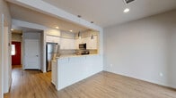 Located at 25 East Maryanna Lane in Hayden Lake, Idaho, this two-story home offers a clean, modern aesthetic throughout. The interior is finished with light wood-look flooring on the main level, complemented by textured walls and crisp white trim that create a bright, welcoming atmosphere.

The kitchen is a standout feature, boasting white cabinetry, light stone countertops, a tile backsplash, and a full suite of stainless steel appliances including a refrigerator, range, microwave, and dishwasher. Stylish pendant lights hang over the peninsula, which opens to the living area and provides easy sight lines to the large sliding glass door and windows that allow natural light to fill the space.

A convenient half bathroom is located on the main floor, finished with wood-look flooring, a white vanity, and modern brushed nickel hardware. A dedicated laundry room on the main level houses a full-size washer and dryer with overhead shelving.

Upstairs, the carpeted bedrooms offer a comfortable, quiet retreat, each with windows that bring in natural light and views of the surrounding neighborhood. The full bathroom on the upper level features tile flooring, a white vanity with ample counter space, and a glass-enclosed shower. The overall design throughout is cohesive, modern, and functional.