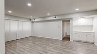Located on Hillside Ave in the hills of Los Angeles, this two-bedroom, two-bathroom residence offers a clean, modern aesthetic throughout its well-appointed single-floor layout. Light wood-style flooring flows seamlessly across every room, creating a cohesive and contemporary feel.

The spacious living room is bright and open, featuring recessed lighting, a soothing neutral color palette, and vertical blinds that provide both privacy and access to natural light. A tasteful blue accent wall adds a subtle pop of color to the space.

The galley-style kitchen is well-equipped with stainless steel appliances — including a refrigerator, range, over-the-range microwave, and dishwasher — complemented by white shaker cabinetry, brushed nickel hardware, and light countertops that give the space a fresh, updated feel.

The generously sized primary bedroom offers a mirrored sliding-door closet and a window with an outdoor view, while the second bedroom also includes a closet and easy hallway access. Both bathrooms are finished in clean white tones with wood-style flooring, brushed nickel fixtures, and glass-enclosed shower areas. The entrance and dual hallways provide smooth transitions between all areas of the home.