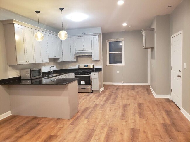 Newly remodeled kitchen with granite countertops and new appliances - 2892 S Archer Ave