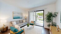Located at 9145 Flying Eagle in Fort Myers, FL, this two-story home offers a well-designed layout across two equally sized floors. The main level features an open-plan living room, dining area, and kitchen. The living room is bright and airy, with large sliding glass doors that open directly onto a patio, allowing abundant natural light and seamless indoor-outdoor flow. The kitchen is outfitted with stainless steel appliances, light grey cabinetry, white quartz countertops, and open shelving, complemented by warm wood-look flooring throughout. A full bathroom with a glass-enclosed walk-in shower, tile flooring, and white vanity is also found on this level. Upstairs, the spacious primary bedroom features plush carpeting, a large window with outdoor views, and access to two closets. A second full bathroom mirrors the clean, modern aesthetic of the first. A loft space adds flexible utility to the upper floor. Outside, two patio areas provide private outdoor living space, one of which features a landscaped yard with turf and decorative stone. Clean white walls, recessed lighting, and consistent modern finishes give the entire home a cohesive, contemporary feel.