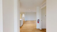 This two-story residence in Laurel, MD offers a clean, modern aesthetic throughout, with light hardwood flooring and a bright, neutral color palette that creates a warm and inviting atmosphere across both levels. The main living area is generously proportioned, featuring recessed lighting and sliding glass doors that open onto a private balcony, filling the space with natural light and outdoor views.

The kitchen is thoughtfully designed with shaker-style cabinetry in a soft white finish, a subway tile backsplash, quartz countertops, and a full suite of stainless steel appliances including a refrigerator, range, microwave, and dishwasher. A central island provides additional prep and dining space, making the kitchen both functional and stylish.

The residence features four bedrooms, each offering hardwood floors, recessed lighting, and windows that bring in ample natural light. The primary bedroom includes a dedicated closet with built-in shelving. Both bathrooms are finished with a cohesive, modern style, featuring subway-tiled tub-shower combinations, undermount sinks with quartz vanity tops, and brushed nickel hardware.

Additional spaces include two hallways, a staircase connecting the two floors, and a closet for storage. The overall design balances practicality with contemporary style throughout.