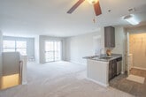 Located at 507 Marcella Rd in Hampton, Virginia, this single-floor residence offers a well-designed layout that balances comfort and functionality. The open-concept living and dining area is finished with plush wall-to-wall carpeting and neutral tones throughout, creating a bright and welcoming atmosphere. A ceiling fan adds comfort to the main living space, which flows seamlessly toward a sliding glass door that opens to a private balcony, allowing for natural light and outdoor views.

The kitchen is thoughtfully appointed with granite countertops, dark cabinetry, stainless steel appliances including an electric range with an over-the-range microwave, and a refrigerator — providing a practical and stylish cooking environment.

The bedrooms are generously sized, each featuring soft carpeting, large windows with blinds that invite natural light, and access to walk-in closets with built-in shelving for ample storage. The bathroom is finished with granite counters, wood-look flooring, and a tub-shower combination. A dedicated in-unit laundry room houses a full-size washer and dryer side by side on wood-look flooring, adding everyday convenience. The overall design is clean, modern, and move-in ready.