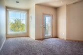 Located at 375 E Main St in Sun Prairie, WI, this one-bedroom, one-bathroom residence offers a well-organized single-floor layout with a thoughtful blend of functionality and comfort. The open-concept living, dining, and kitchen area forms the heart of the home, where warm neutral tones and a mix of carpet and tile flooring create an inviting atmosphere. Vaulted ceilings with pendant lighting add a sense of height and airiness to the space, while a ceiling fan in the living room enhances comfort year-round. Large windows and a sliding patio door allow natural light to flow freely throughout.

The kitchen is well-equipped with light wood cabinetry, laminate countertops, black appliances including an electric range, overhead microwave, and refrigerator, along with a peninsula that doubles as a breakfast bar. A built-in desk nook near the entry provides a convenient workspace.

The bedroom features soft carpet flooring, a natural light window, and ample closet storage with sliding wood-panel doors. The full bathroom is finished with tile flooring, a vanity with storage, and a glass-door shower. Four closets throughout the unit offer generous storage. The private balcony overlooks a tree-lined neighborhood, providing a pleasant outdoor retreat.