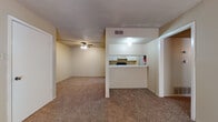 Located at 9110 Broadway St in San Antonio, Texas, this single-story unit offers a practical and functional layout designed for comfortable everyday living. The spacious living area features wall-to-wall carpeting, a ceiling fan, and a textured ceiling, creating a warm and inviting atmosphere. A sliding glass door allows natural light to filter in, adding brightness to the open space. The kitchen is accessible via a pass-through counter that opens to the living area, providing a connected feel between the two spaces. Inside, the galley-style kitchen is equipped with white cabinetry, a coil electric range, a full-size refrigerator, and a double-basin stainless steel sink, all set atop rich hardwood-style flooring. The bedroom is generously sized with plush carpeting, a ceiling fan, a window with blinds for natural light, and access to a spacious walk-in closet offering ample storage. The bathroom features a full vanity with a light-colored countertop, white cabinetry, a large mirror, and a separate water closet with a soaking tub and tile surround. Throughout the unit, neutral tones and clean finishes provide a versatile canvas well-suited for a variety of personal styles.
