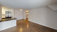 Located at 700 E Cathedral Road in the Roxborough neighborhood of Philadelphia, this single-floor unit offers a thoughtfully laid-out interior with a blend of updated finishes and classic architectural details. The open living area is anchored by rich parquet hardwood flooring and flooded with natural light through large sliding glass doors that lead to a private balcony, providing outdoor views and a seamless indoor-outdoor connection. A peninsula counter separates the living space from the kitchen, adding both function and definition to the open floor plan.

The kitchen has been updated with white shaker cabinetry, dark countertops, a white subway tile backsplash, and a full suite of stainless steel appliances, including a gas range, over-the-range microwave, dishwasher, and refrigerator. Light wood-tone flooring completes the kitchen's clean, contemporary aesthetic.

The bedroom features warm hardwood flooring, a double-panel closet, and a window offering views to the street. The bathroom includes a full tub-shower combination finished with white tile, brushed nickel fixtures, and accessibility grab bars. A dedicated laundry area with a stacked washer and dryer is conveniently accessible from the main living space, adding everyday practicality to this well-appointed unit.