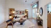 Located at 410 Walker Springs Rd in Knoxville, TN, this well-appointed one-bedroom, one-bathroom unit offers a thoughtfully designed open-concept floor plan across a single level. Light-toned hardwood-style flooring flows throughout, unifying each space under soaring ceilings that enhance the sense of openness.

The kitchen is a standout feature, equipped with stainless steel appliances, white shaker-style cabinetry, a classic subway tile backsplash, and a contrasting blue island with bar seating — all anchored by a bold pendant light overhead. The adjacent living room benefits from tall windows, transom-level glazing, and French doors that invite abundant natural light and provide outdoor access, creating an airy, connected atmosphere.

The bedroom offers a cozy yet bright retreat, featuring a wraparound bay window configuration that frames exterior views and fills the room with daylight. A well-organized walk-in closet includes built-in shelving, dual hanging rods, drawers, and dedicated shoe storage.

The bathroom is finished with large-format neutral tiles, a walk-in shower with glass enclosure, a white vanity with ample counter space, and open wall shelving for convenient storage. Every room reflects a clean, contemporary aesthetic suited for modern living.