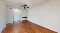 Located at 1600 Marina Rd in Irmo, SC, this single-story, one-bedroom, one-bathroom unit offers a thoughtfully designed layout that makes efficient use of its floor space. The open-concept living and dining area is finished with warm hardwood-style flooring, crown molding, and a ceiling fan, creating a bright and comfortable atmosphere. Multiple windows along the exterior wall allow natural light to fill the space, while a private entry door provides convenient access.

The galley-style kitchen is a standout feature, equipped with rich dark wood cabinetry, dark granite countertops, a tile backsplash, and black appliances including a refrigerator and range. Track lighting overhead and a pendant light above the peninsula add both task and ambient illumination. The peninsula counter also provides a casual dining or prep area.

The bedroom features plush wall-to-wall carpeting, a ceiling fan, a window with exterior views, and access to a dedicated closet. The bathroom includes a full tub-shower combination with white tile surround, tile flooring, and brushed nickel fixtures throughout.

A built-in bench near the entryway adds a practical touch to the living area, rounding out a functional and comfortable single-floor residence.
