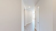 Located at 6201 Forge Cir in Lawrence Township, NJ, this thoughtfully designed 2-bedroom, 2-bathroom single-floor residence offers a clean, contemporary aesthetic throughout. Light-toned hardwood-style flooring flows seamlessly across the entire space, complemented by neutral white and soft gray walls that maximize the natural light streaming in through multiple windows fitted with blinds.

The open-concept kitchen is a standout feature, showcasing a large central island with a crisp white quartz countertop, gray flat-front cabinetry, a classic white subway tile backsplash, and a full suite of stainless steel appliances including a refrigerator, range, microwave, and dishwasher. The kitchen opens directly into the living area, creating an ideal layout for everyday living and entertaining.

Both bedrooms are generously proportioned, with the primary bedroom offering ample space and natural light. Each room includes dedicated closets, providing practical storage. The two hallways connect the living areas to the bedrooms and bathrooms efficiently.

The bathrooms are stylishly finished — one features wood-toned tile surround in a glass-enclosed walk-in shower, while the second includes a full tub-shower combo, each with modern vanities and recessed lighting. The result is a well-appointed, move-in-ready home with a cohesive modern design.