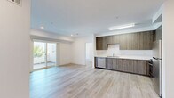 Located at 3057 W Pico Blvd., Unit 401 in Los Angeles, this well-appointed 2-bedroom, 2-bathroom residence offers a clean, modern aesthetic throughout. Light wood-tone flooring flows seamlessly across all living areas, complementing the bright white walls and recessed lighting that keep the space feeling open and airy.

The open living room is generously sized and bathed in natural light, with sliding glass doors that lead to a private balcony offering outdoor views. The kitchen is efficiently designed with floor-to-ceiling wood-tone cabinetry, white countertops, and a full suite of stainless steel appliances including a gas range, microwave, dishwasher, and refrigerator.

The spacious primary bedroom features mirrored sliding closet doors that enhance the sense of space and reflect natural light. The second bedroom is bright and well-proportioned, with a large window. Both bathrooms are finished with clean white surrounds and tub-shower combinations with chrome fixtures.

A dedicated in-unit laundry area with a stacked washer and dryer adds everyday convenience. The hallway and closet provide additional storage throughout. The unit's modern finishes, natural light, and functional layout make it a well-rounded residence in the heart of Los Angeles.
