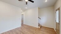 Located in Lake Charles, Louisiana, this two-bedroom, two-bathroom residence spans two floors with a practical and well-organized layout. The main level houses the primary living areas, including an open living room with light wood-look flooring, a ceiling fan, recessed lighting, and a staircase leading to the upper level. Natural light filters in through multiple windows fitted with horizontal blinds, giving the space a bright and airy feel. The kitchen is arranged in an L-shape and features gray shaker-style lower cabinets, neutral upper cabinetry, granite-look countertops, and black appliances including a refrigerator, range, microwave, and dishwasher. A window over the sink adds additional natural light. The main level also includes a bathroom with a tub-shower combination and wood-look flooring. Upstairs, two bedrooms offer comfortable accommodations, each with wood-look flooring and ample natural light from multiple windows. The primary bedroom includes a double-door closet and direct access to a full bathroom featuring a granite-topped vanity, tub-shower combination, and brushed nickel fixtures. A hallway connects the upper-level rooms. Throughout, the interiors maintain a clean, neutral palette with white walls and consistent wood-look flooring, creating a cohesive and move-in-ready environment.
